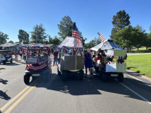 3 golf carts decorated for a 4th of July parade