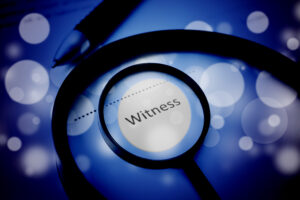 The word witness surrounded by a magnifying glass