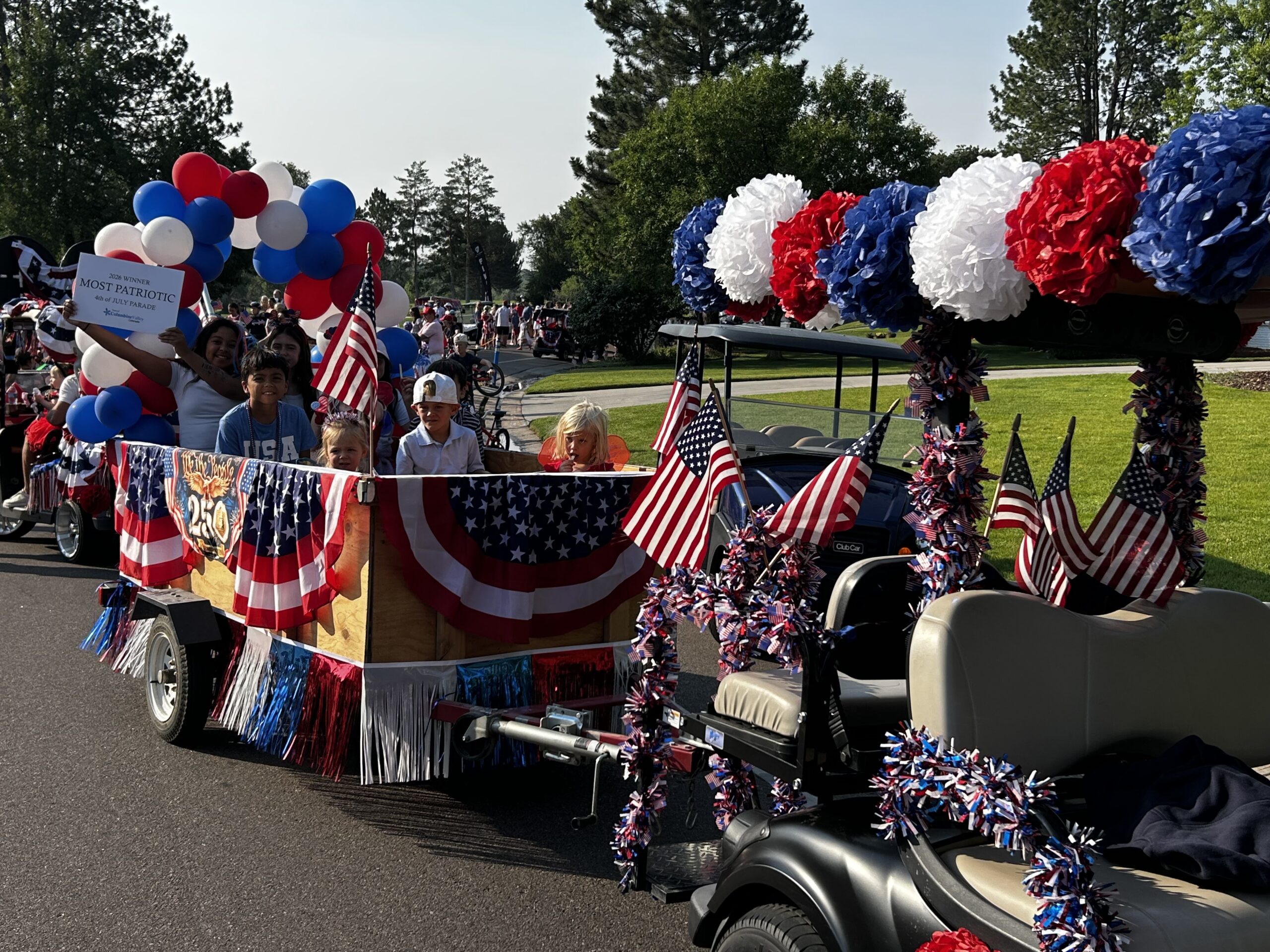golf cart decorated with red, white and blue balloons and streamers